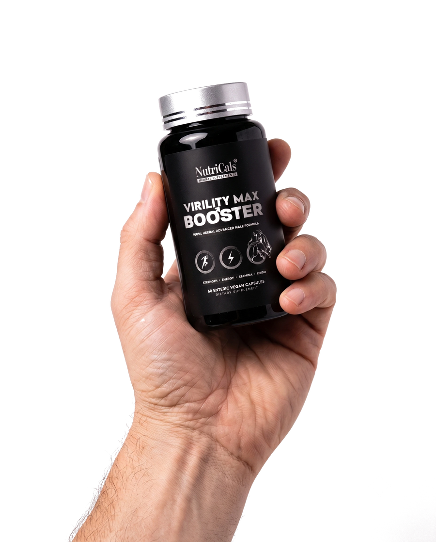 A hand holding the NutriCals Virility Max Booster bottle